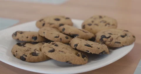 Extreme close-up of plate with biscuits standing on the table as little Video stock 135964423