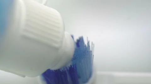 Extreme close up; Putting tootpaste on a toothbrush Stock Footage 172135721