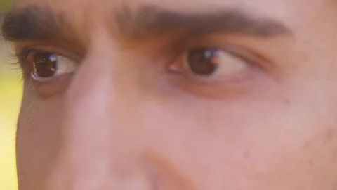 Extreme close up - rack focus of young man's eyes - Slow Motion - shot on RED Stock Footage 125167469