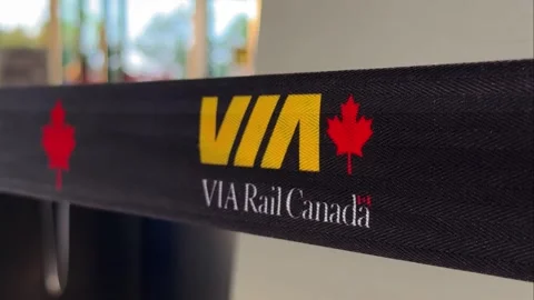 Extreme close-up of VIA Rail Canada logo and red maple leaf emblem printed Stock Footage 342641665