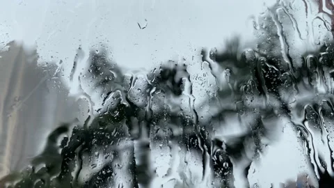 Extreme close up of Rain drops falling on a glass window Stock-Footage 134419477
