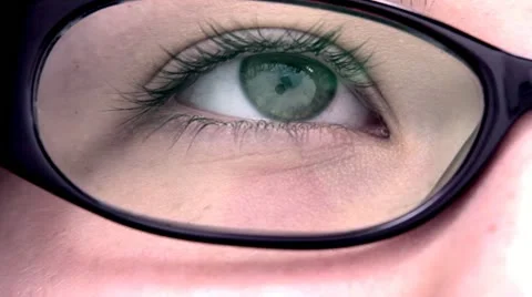 Extreme close up of an reading eye through the glasses. Stock Footage 12402933