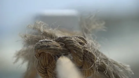 Extreme close up of a rope on blurred beige background. camera focus sliding Stock Footage 157968271