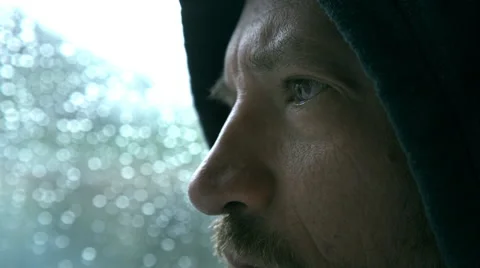 Extreme close up of a sad  and  pensive man in front of  the window  Stock Footage 55419295
