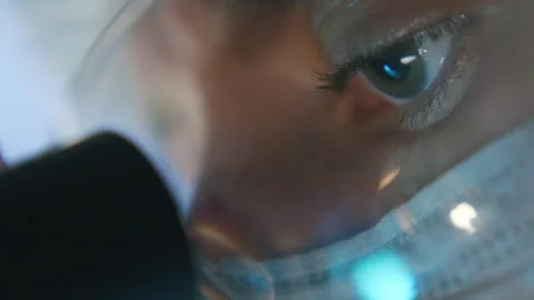 Extreme Close Up of Scientist Looking through Microscope during Research Stock Footage 315131238
