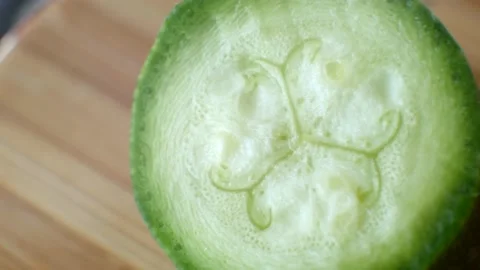 Extreme close up section of freshly picked cucumber cut in half Video stock 139765647