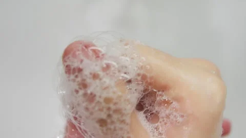 Extreme close-up sequence of hands being thoroughly washed, with rich soap Stock Footage 317544849