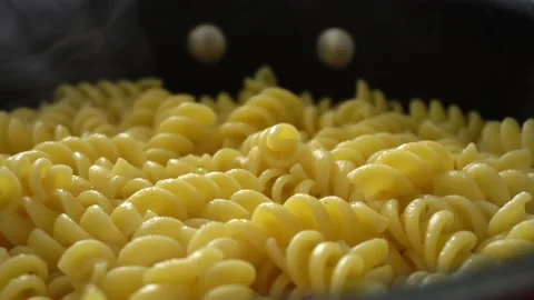 Extreme close-up of several freshly boiled and smoking yellow screw-shaped Stockbeeldmateriaal 181775985