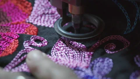Extreme close up of sewing machine stitching flower pattern. Making a Stock Footage 169831836