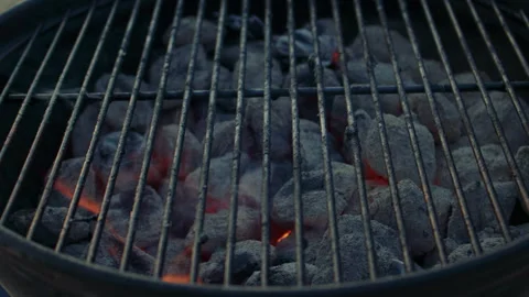 Extreme close-up shot of a brazier with grilling grate on and burning charcoal 스톡 동영상 285470295