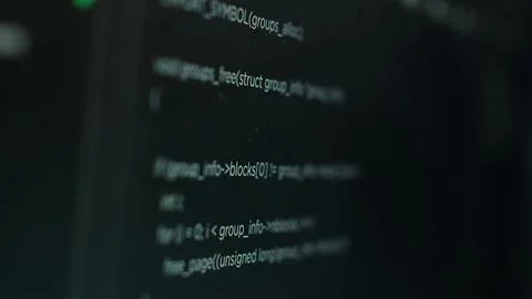 Extreme close up shot of hacking code running on computer system monitors 写真素材