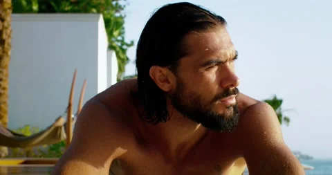 Extreme close up shot of man resting in pool in fancy hotel. Video stock 209943348