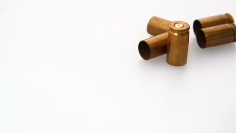 Extreme close up shot of rotating bullet shells on white background. Stock Footage 117542818