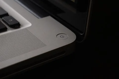 Extreme close up silver power button on a smart computer or laptop. Stock Photos