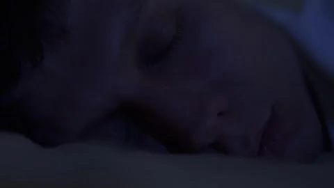 Extreme close-up of a sleeping young man at night. Calm breathing, relaxed face Stock Footage 320787032