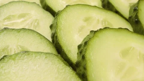 Extreme close-up of sliced cucumbers captured with a sliding motion. 스톡 동영상 313832855