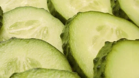 Extreme close-up of sliced cucumbers captured with a sliding motion. Stock Footage 313832868