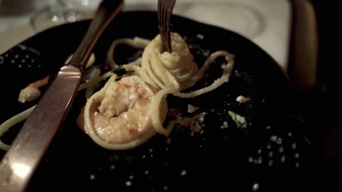 Extreme close up Slow Motion fork turning pasta shrimp on plate NYC 4k Stock Footage 255755573