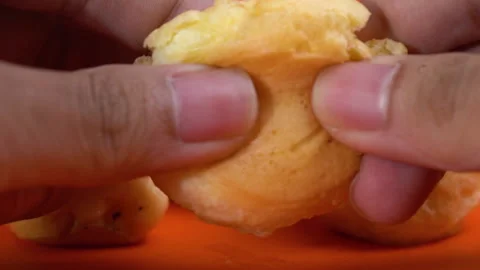 Extreme close up slow-motion splitting the eclair showing the softness Stock-Footage 135641664