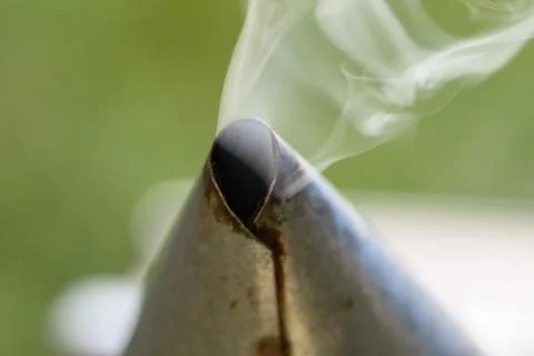 Extreme close-up of smoke exiting bee smoker opening Stock Photos