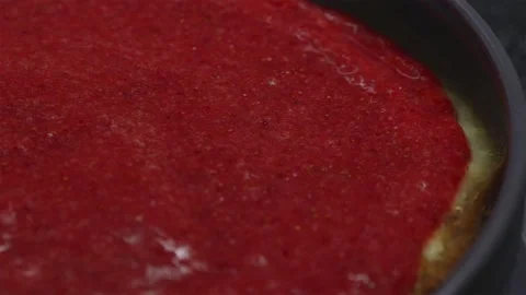 Extreme close up of spreading vibrant strawberry glaze on cake Stock Footage 340610669