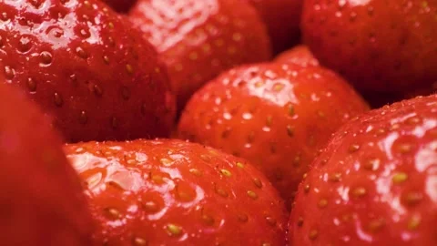 Extreme close-up of strawberries captured with a sliding motion. 스톡 동영상 313802414