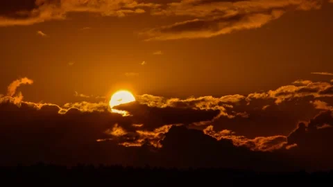 Extreme close up of sun setting on the cloudy sky Stock Footage 132242386