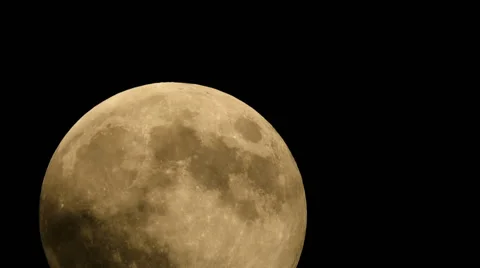 Extreme close up supermoon rising through night clouds Stock Footage 41588976