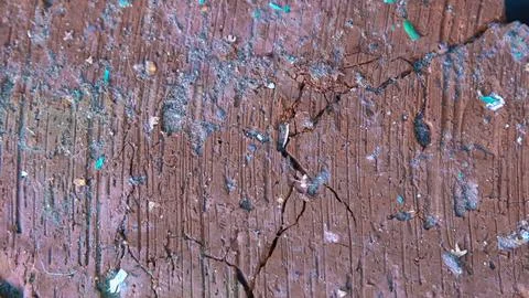 Extreme close-up of the surface of old red brick with deep furrows, cracks and Fotos Stock