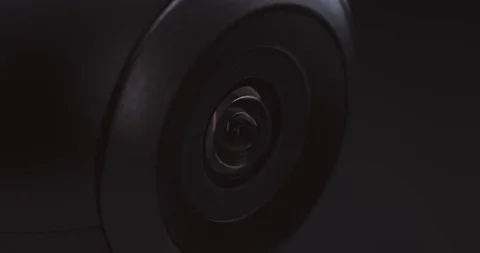 Extreme close-up of a surveillance camera watching and tracking Stock Footage 121017865
