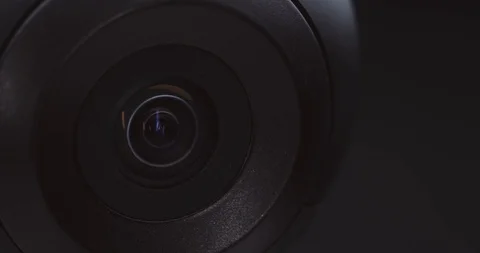 Extreme close-up of a surveillance camera watching and tracking Stock Footage 121017936