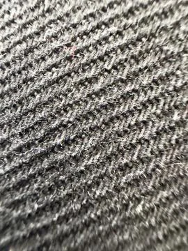 Extreme close-up texture of dark grey woven fabric showing intricate thread.. Stock Photos