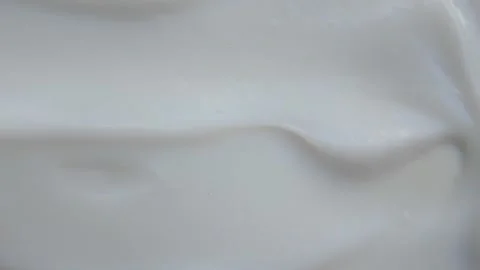 Extreme Close-up of Thick White Cream Swirling Stock Footage 340851207