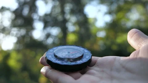 Extreme close-up of a transparent modern compas in the forest background Stock Footage 138858488