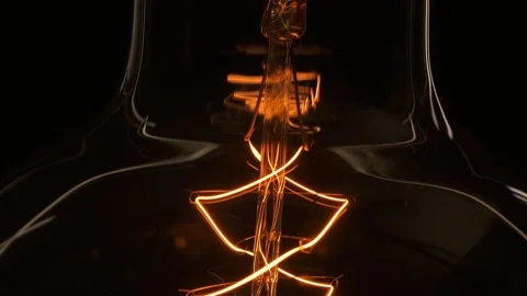 Extreme close up tungsten old Edison retro lamp turn on. light bulb threads are Stock Footage 135175445