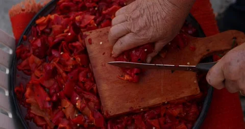 Extreme close-up of two old hands finely chopping red pepper and preparing it fo 스톡 동영상 207718340