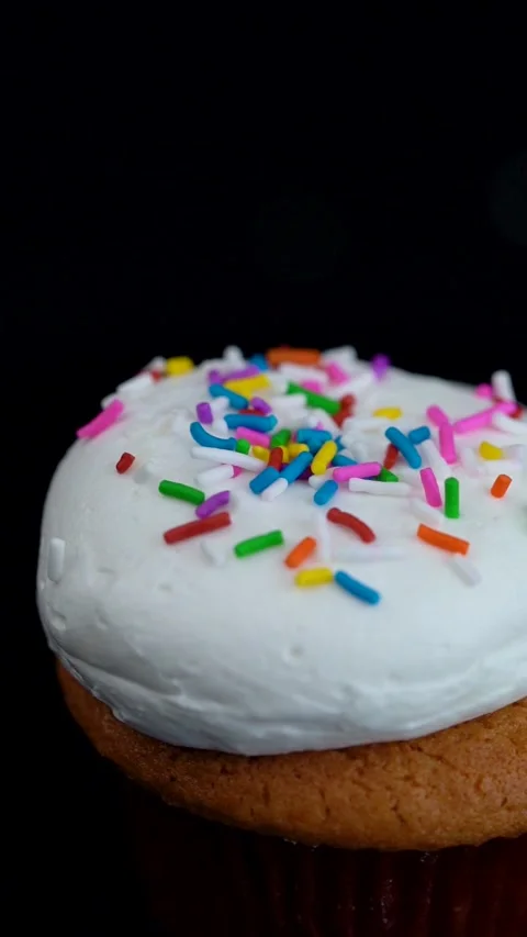 Extreme Close Up Vanilla Cupcake with Colorful Sprinkles Rotating Stock Footage 330516792