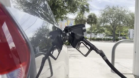 Extreme close up video of a gas pump nozzle fueling a car Stock Footage 343668551