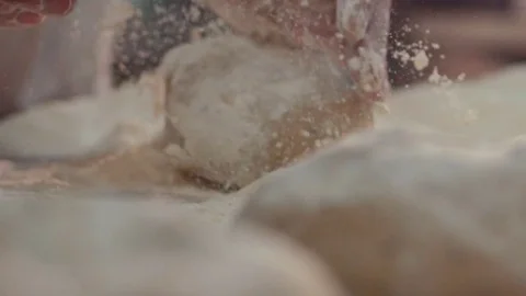 Extreme close up view of baker’s hands one by one kneading the pieces of dough Video stock 77521193