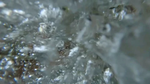 Extreme close-up view on boiling water in a kettle with bubbles Stock Footage 107922253