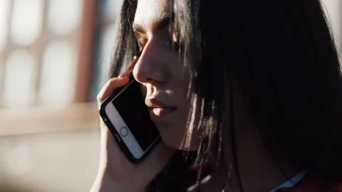 Extreme close up view of good looking young brunette woman communicating via Stock Footage 111220343