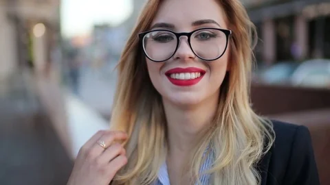 Extreme close up view of a pretty blonde woman in a stylish look, with red Stock Footage 76909826