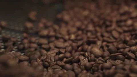 Extreme close up view of roasted coffee beans in a process of mixing Video stock 69081748
