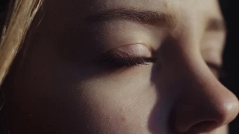 Extreme close up view of sad calm blue-eyed European woman looking into the Stock Footage 84643811