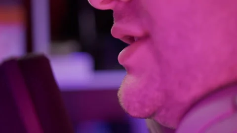 Extreme close up view of streamer player playing computer game and commenting on Stock Footage 244162566