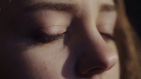 Extreme close up view of stunning blue-eyed woman opening her eyes, taking a Stock Footage 84643829