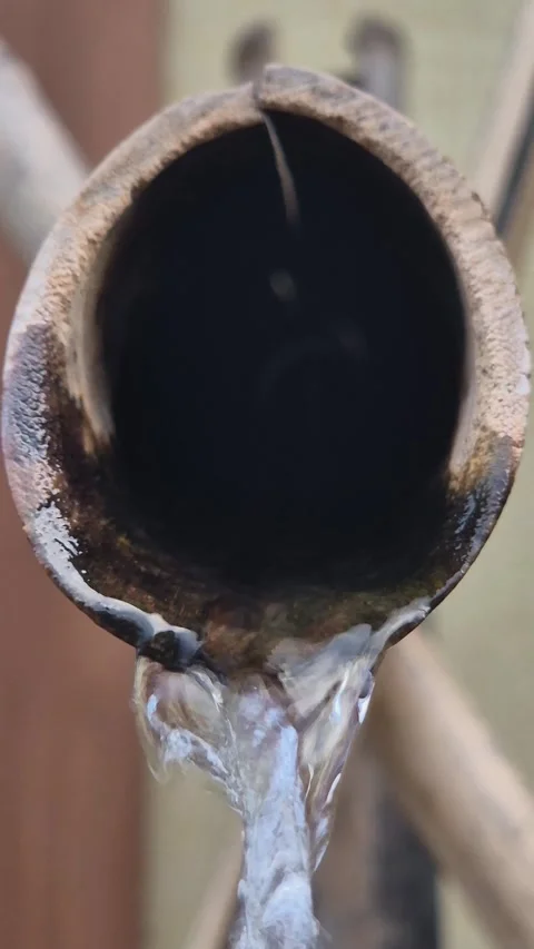 Extreme close up of water dripping from a pipe conceptualizing drought and water Stock Footage 341755038