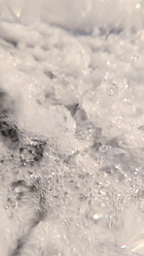 Extreme close-up of waterfall below, rushing stream of falling water foaming and Stock Footage 323380105