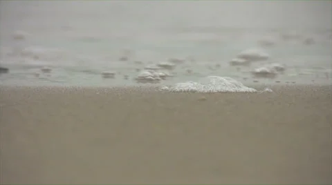 Extreme close up of wave lapping sandy shore. Stock Footage 42784919