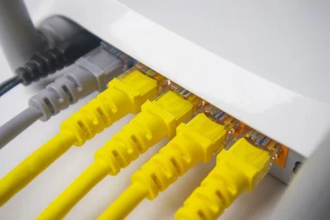 Extreme close-up of a white router's back panel with four yellow and one gr.. Stock Photos